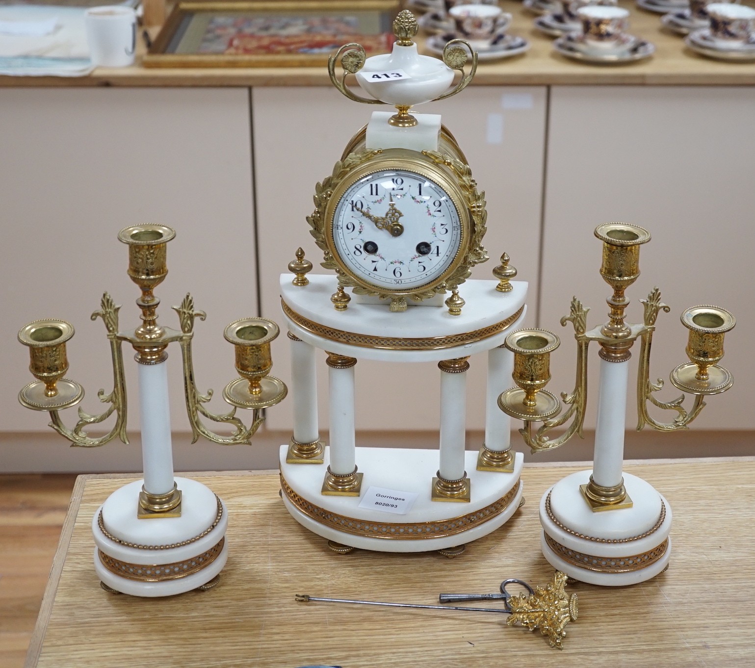 A classical revival white marble and only three-piece clock garniture, early 20th century. 42cm high